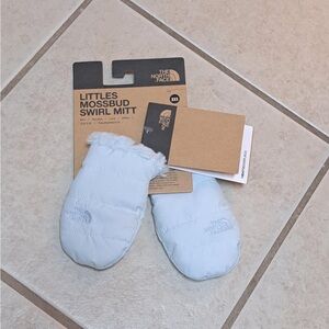 The North Face Littles Mossbud Swirl reversible mittens in a light blue color